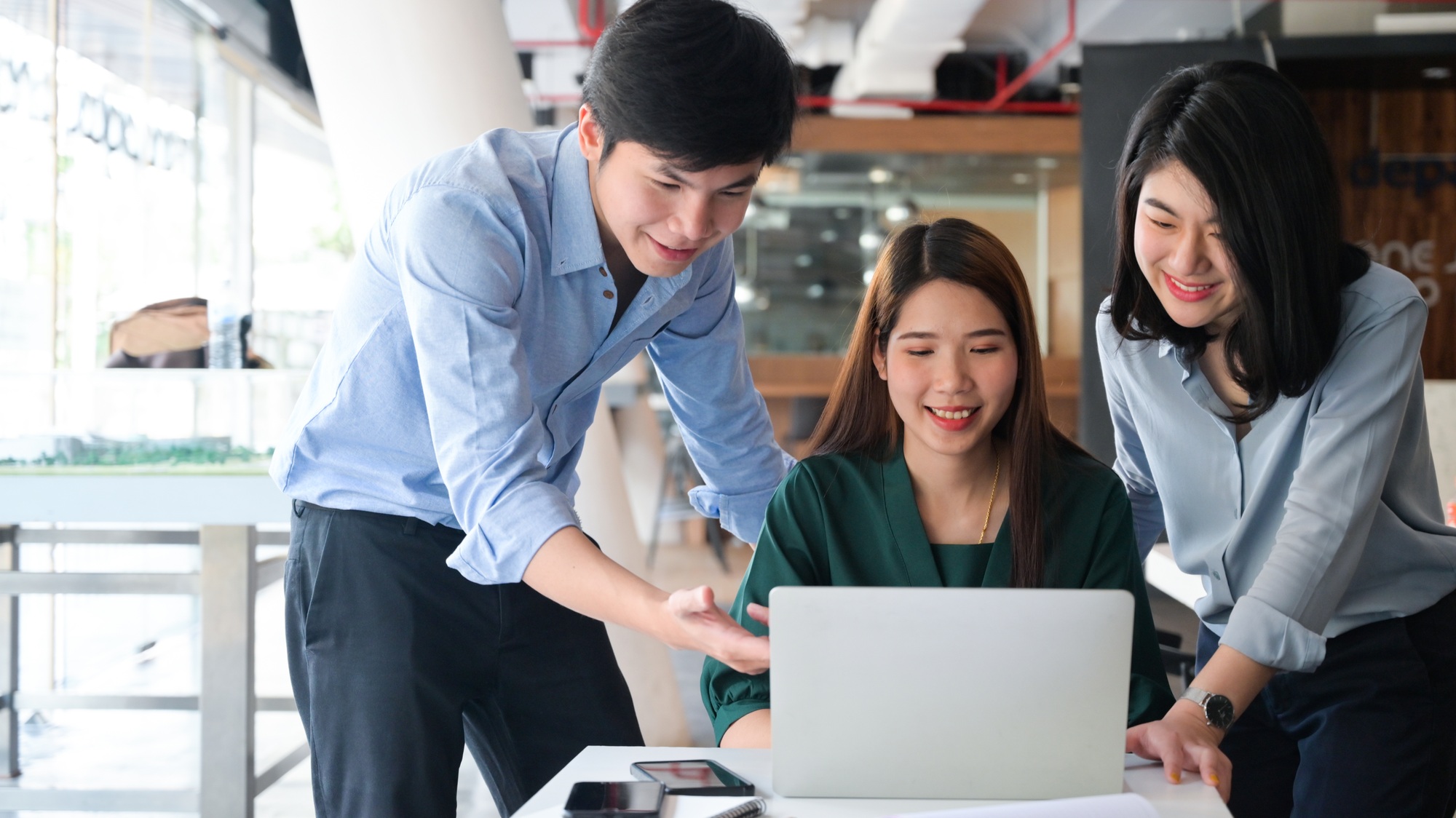 Real estate brokerage team using laptop with smile, Real estate trading, Business concepts.